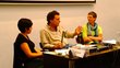 Two women and one man sitting on the panel